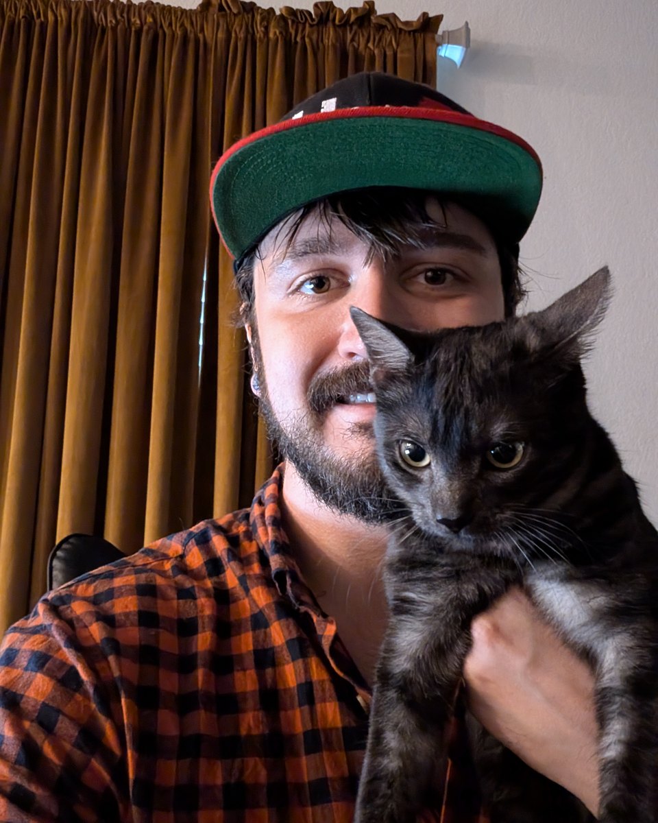 Kyeson Blake Utley, founder of GhostKey Development, holding his cat
